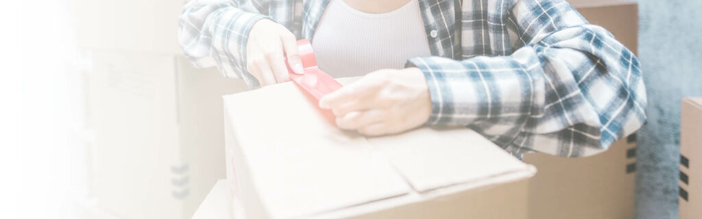Removals companies in nine elms - image of packing box being taped up for a move