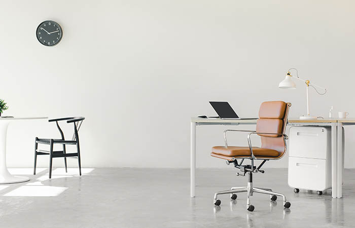 Office furniture to represent dealing with furniture after a business moves to a hybrid working model.